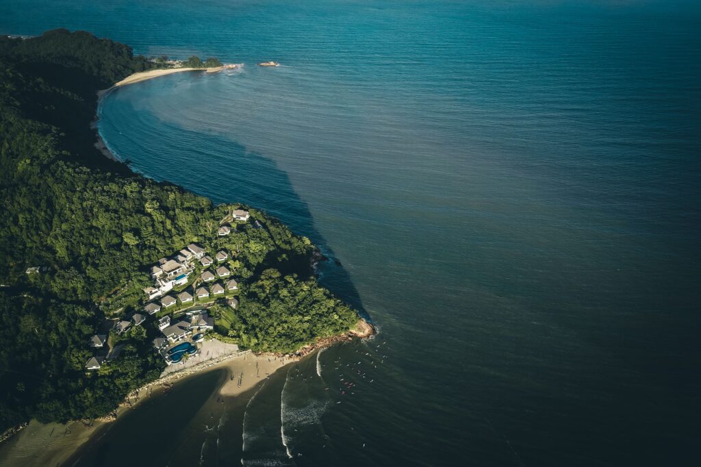 Stunning aerial view of Balok Beach, Pahang, Malaysia showcasing lush greenery and serene ocean waters.