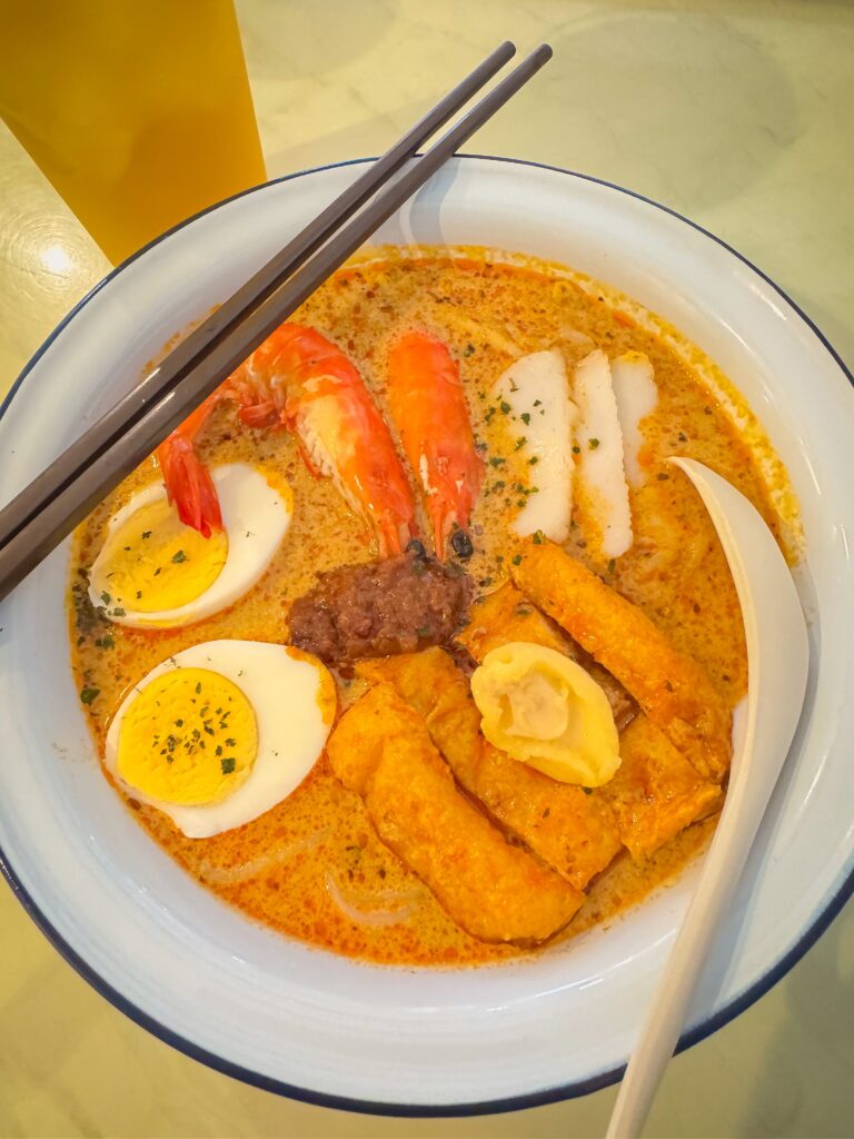 Tantalizing spicy seafood laksa with shrimp, egg, tofu, and fish cake.